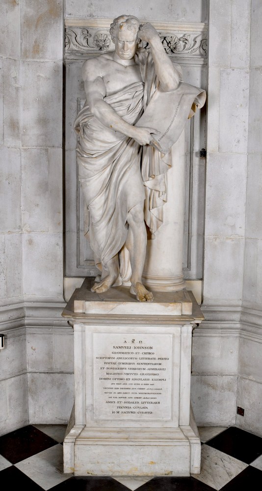 White marble monument showing fukl-length figure of a man draped in toga-like robes and leaning on a pillar