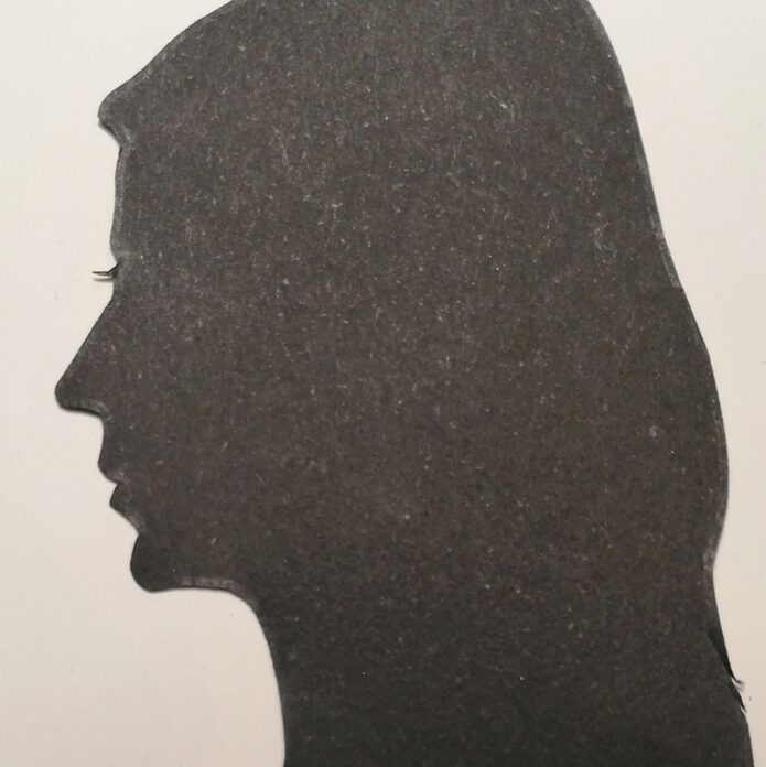 Silhouettte of a long-haired young woman in left-facing profile