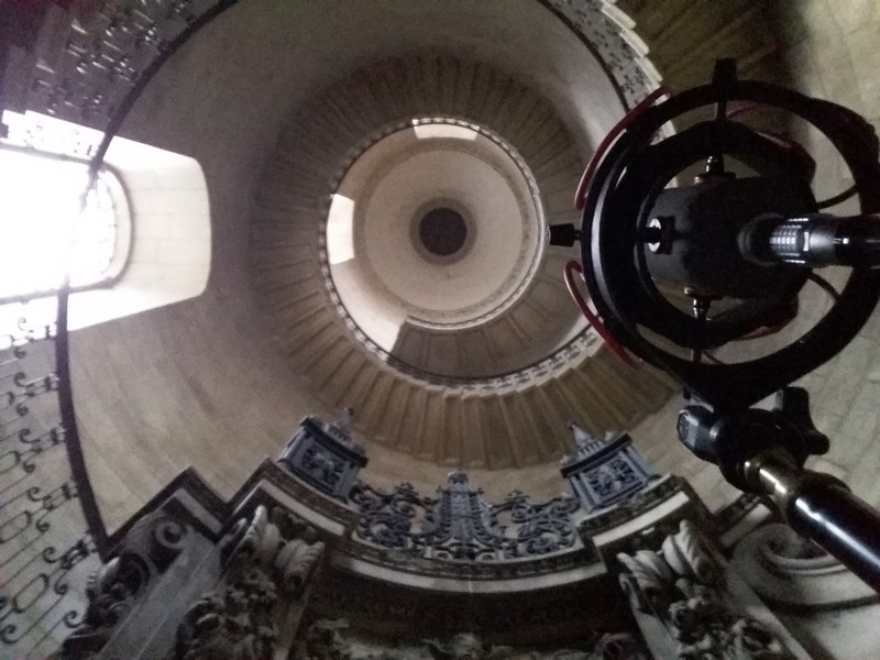 View up a spiral staircase at St Paul's Cathedral with a microphone on a tripod in the foreground