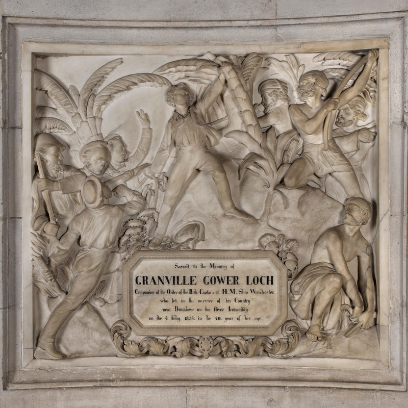 Marble sculpted panel showing a battle in the jungle, with an inscription