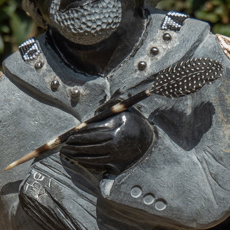 sculpture detail - hand holding quill